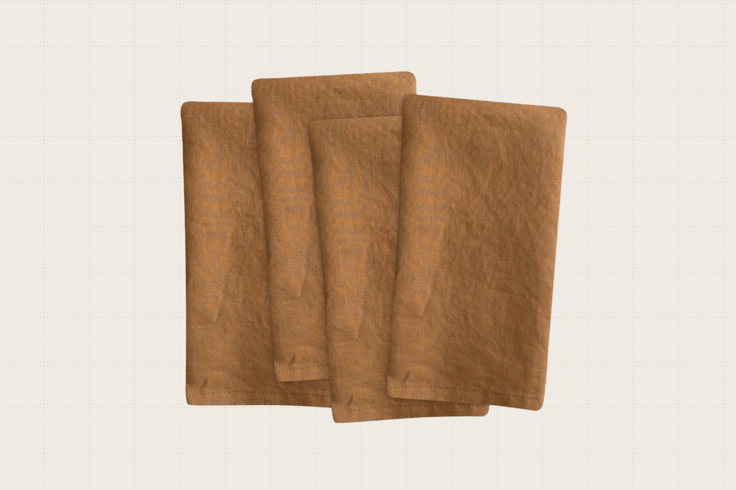 A set of four European linen napkins from Quince in the color 'Terracotta.' They have a smooth texture and measure 20 inches square.