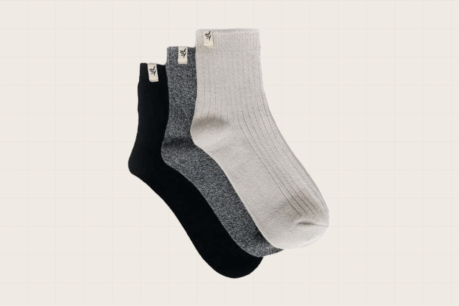 Three pairs of crew cut length socks in oatmeal, heather gray, and black.