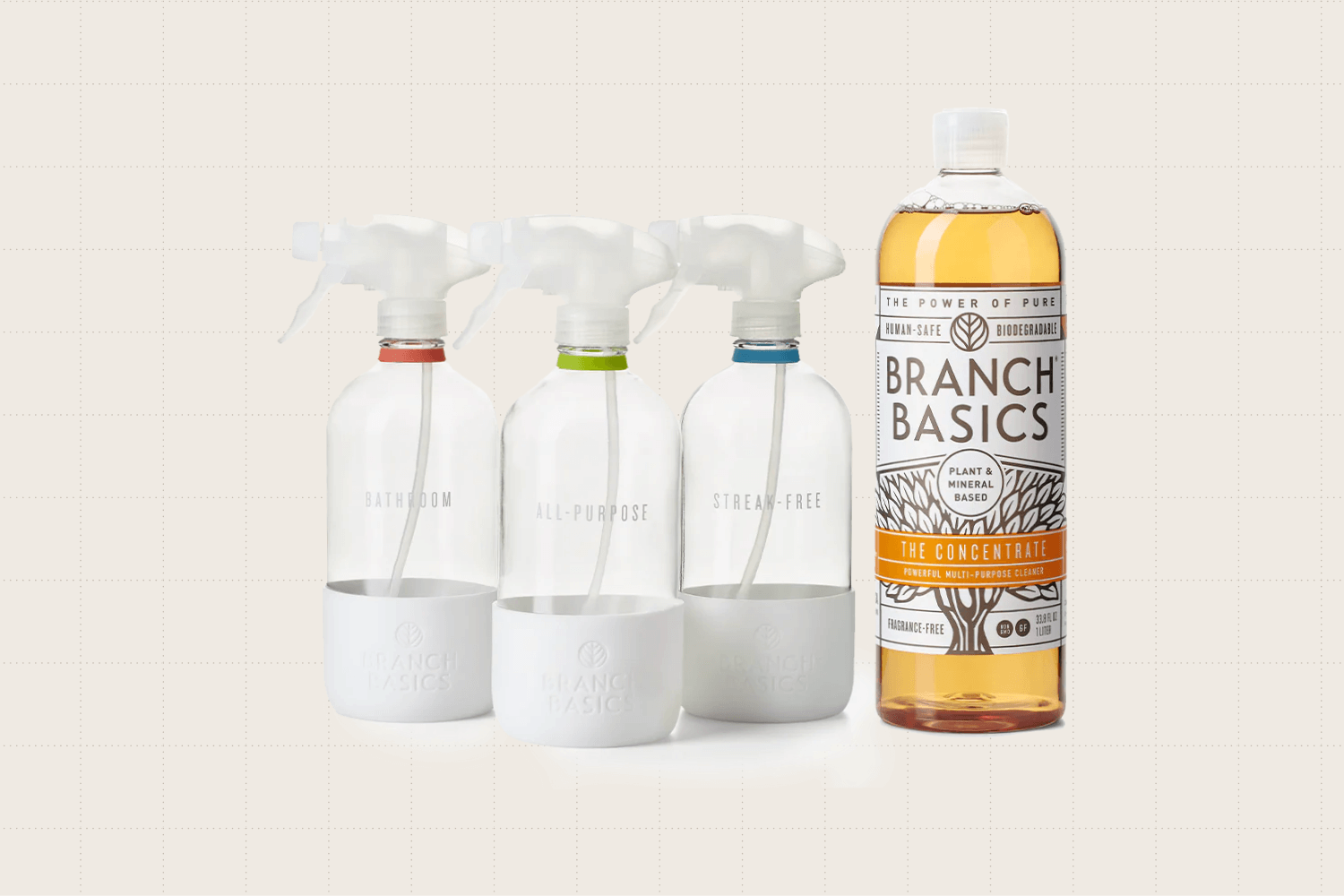 The Branch Basics Cleaning Essentials Kit in glass. It includes three sustainable glass bottles labeled: All-Purpose Bottle, Bathroom Bottle, and Streak-Free Bottle. You also get a multi-purpose cleaning solution that can be diluted with water.