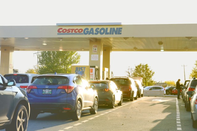 Image of a long line at a Costco gas station during golden hour.